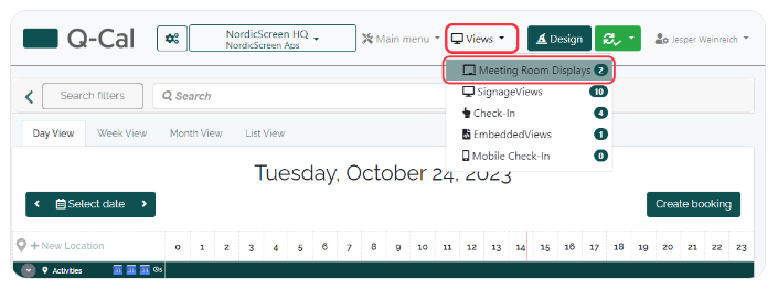 Q-Cal scheduling interface showing 'Views' dropdown menu with 'Meeting Room Displays' option highlighted for October 24, 2023.