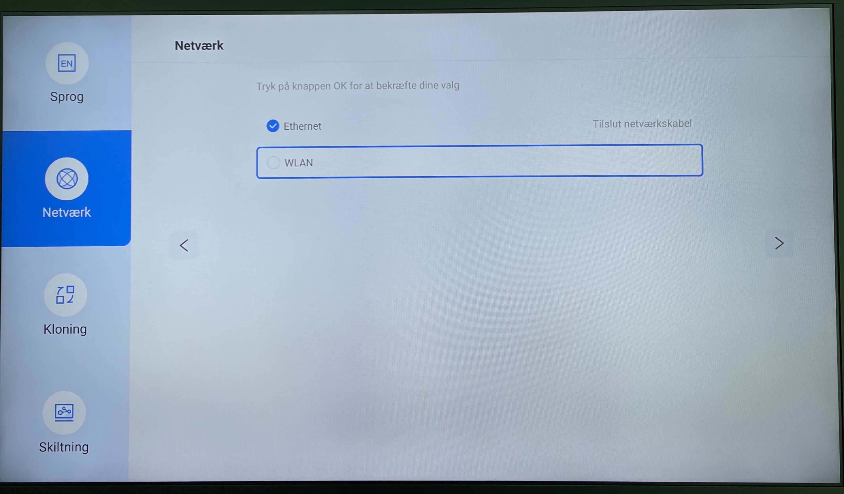 Settings screen with network options, Ethernet selected and WLAN option available, with a prompt to press OK to confirm choices.